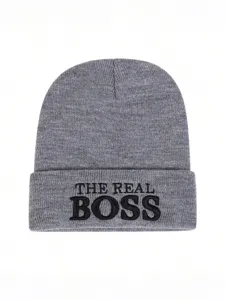 Close up of grey knitted beanie hat with black embroidery detail, comfortable winter wear.