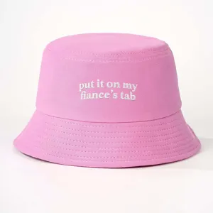 Pink embroidered bucket hat detail showing text design for casual outdoor wear and sunny days.