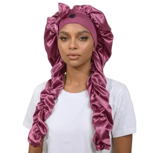 Silk satin long sleep bonnet with bow detail and button, perfect for hair protection and night sleep.