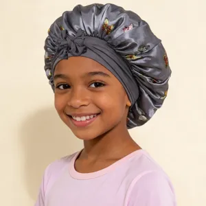 Children satin sleep bonnet with butterfly print and cute bow strap for hair care.