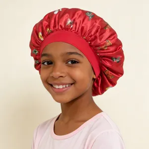 Detail view of the red satin hair bonnet featuring colorful butterflies and a wide elastic band.