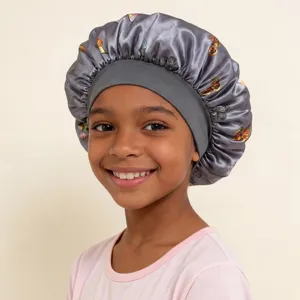 Close-up detail of kids satin sleep bonnet featuring vibrant butterfly print and elastic band.