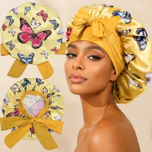 Detail shot of the butterfly print satin sleep bonnet with adjustable ribbon ties for hair care.