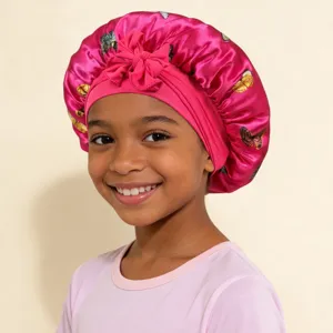 Kids satin sleep bonnet with cute butterfly print and bow detail, soft hair care cap for girls.