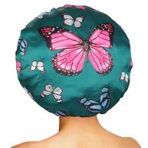Close-up detail of the colorful butterfly print satin hair bonnet, showing soft green fabric texture.