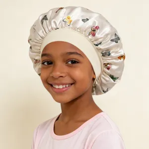 Close-up view of a child wearing a satin butterfly print sleep cap with wide elastic band.