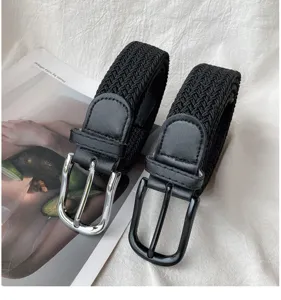 Woven stretch belt close-up, elastic nylon braided strap with metal pin buckle detail.