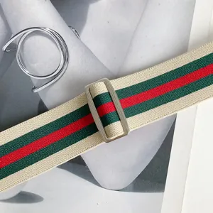 Elastic stretch waist belt with classic red and green stripes and silver metal buckle.