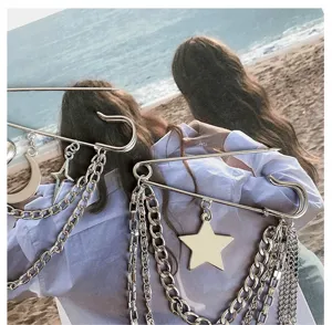 Silver safety pin brooch with multi-layer metal chains and star moon charms for pants waist adjustment.