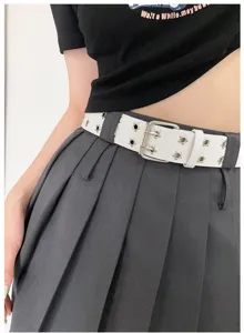 Close-up of a white Y2K punk grommet belt with star eyelets and double pin buckle detail.