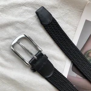 Black woven elastic belt for men and women, minimalist holeless design with silver metal pin.