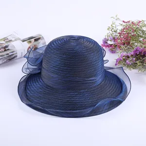 Details of the elegant navy blue organza sun hat with ruffled brim and fine texture.