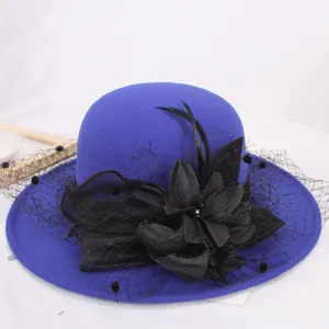 Blue wool cloche hat with black mesh and flower detail for elegant autumn winter fashion.