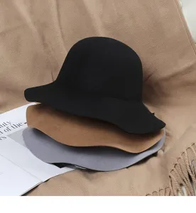 Detailed view of fashionable wool felt bucket hats in black, brown and grey colors.