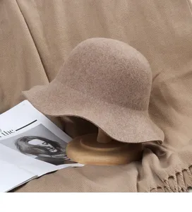 Detailed view of the elegant wool felt bucket hat, showcasing the wavy brim texture and cozy fabric.