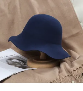 Dark blue wool bucket hat detail, elegant wavy brim design for autumn and winter daily wear.