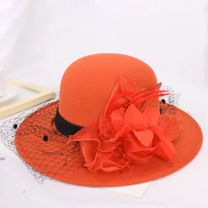 Elegant orange wool felt hat with black mesh and red flower detail for autumn and winter.