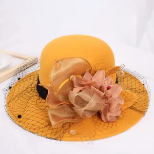 Yellow wool felt bucket hat with mesh veil and floral decoration for women winter fashion.