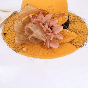 Yellow wool hat detail featuring elegant fabric flower and black mesh veil for women autumn winter.