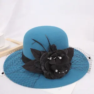 Elegant blue wool felt hat with black floral mesh veil, vintage Hepburn style winter bowler.