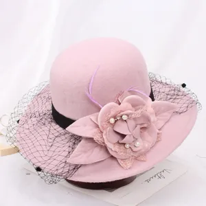 Pink wool felt bucket hat with black mesh veil, elegant floral and feather details.