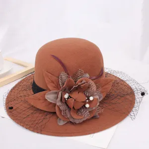 Elegant brown wool felt bucket hat featuring vintage mesh veil and floral decoration.