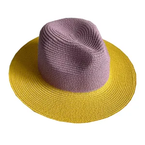 Close-up detail view of the purple crown and yellow brim colorblock straw sun hat.