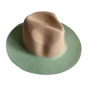 Detail shot of the two-tone straw hat showing its fine woven texture and green brim.