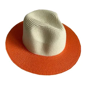 Two-tone straw fedora hat detail with cream crown and orange wide brim for summer beach.