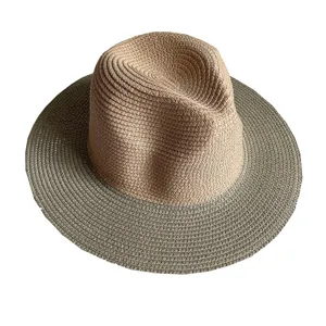 Detailed view of two-tone straw fedora hat, classic summer sun beach hat with wide brim.