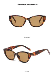Occhiali da sole cat-eye alla moda con montatura tartaruga e lenti marroni stile elegante.