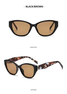 Dettaglio occhiali da sole occhio di gatto, montatura nera lente marrone, stile chic primo piano.