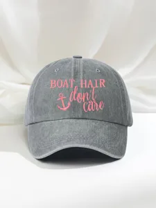 Detailed view of the grey washed cotton baseball cap featuring pink embroidered slogan and anchor.