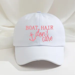 White embroidered baseball cap with pink boat hair phrase and cute anchor graphic.