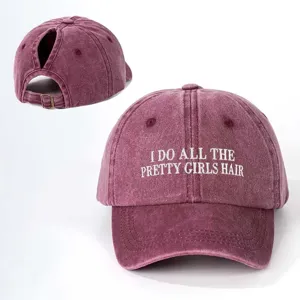 Detail view of the washed maroon ponytail baseball cap featuring white embroidered text.