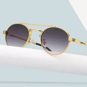 Chic gold-rimmed round sunglasses with gradient lenses, stylish double-bridge detail for street fashion.