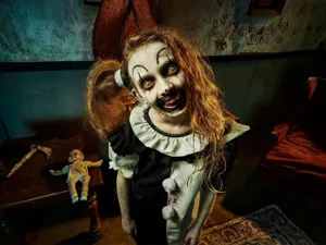 Detailed view of kids Terrifier clown cosplay costume, black white horror jumpsuit for Halloween.