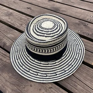 Black and white woven straw hat, flat brim sun hat for women summer beach fashion.