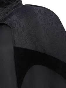 Medieval gothic vampire costume detail with black jacquard fabric and velvet stand collar.