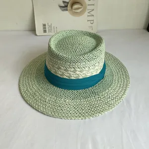 Detailed view of a light green flat top straw hat with teal ribbon band, summer beach sun hat.