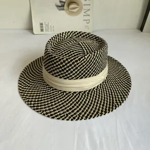Black and beige woven boater hat with a cream ribbon, detail shot for summer sun protection.