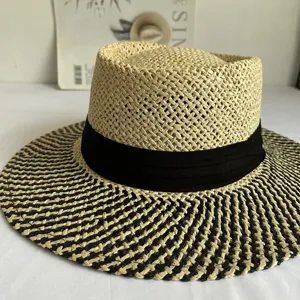 Retro British flat top straw hat with black band, stylish summer beach sun protection.