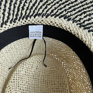 Woven straw sun hat detailed view showing paper material and inner label craftsmanship.