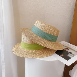 Vintage flat top straw hat with green ribbon, stylish summer beach sun protection hat.