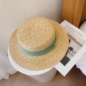 Retro British flat top straw hat detail, natural straw weaving with elegant green ribbon for summer.
