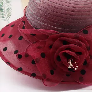Detailed close-up of a women's maroon organza sun hat featuring delicate polka dots and mesh.