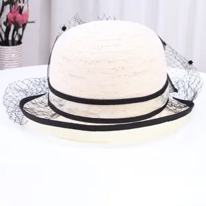 Détail de chapeau de soleil vintage en dentelle blanche, élégant voile noir et ruban.