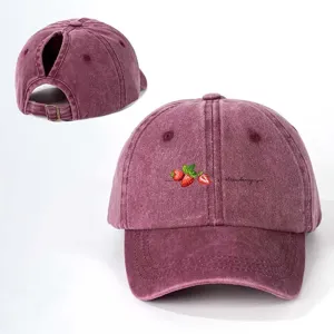 Washed cotton ponytail baseball cap with cute strawberry embroidery, adjustable strap.