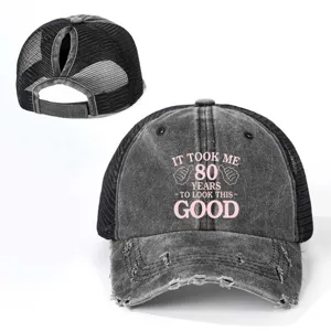 Close-up of distressed mesh ponytail baseball cap with novelty text and back slot.