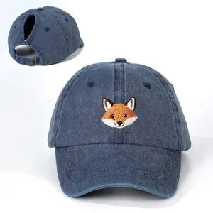 Detailed view of the cute fox embroidery and ponytail hole on the washed denim baseball cap.
